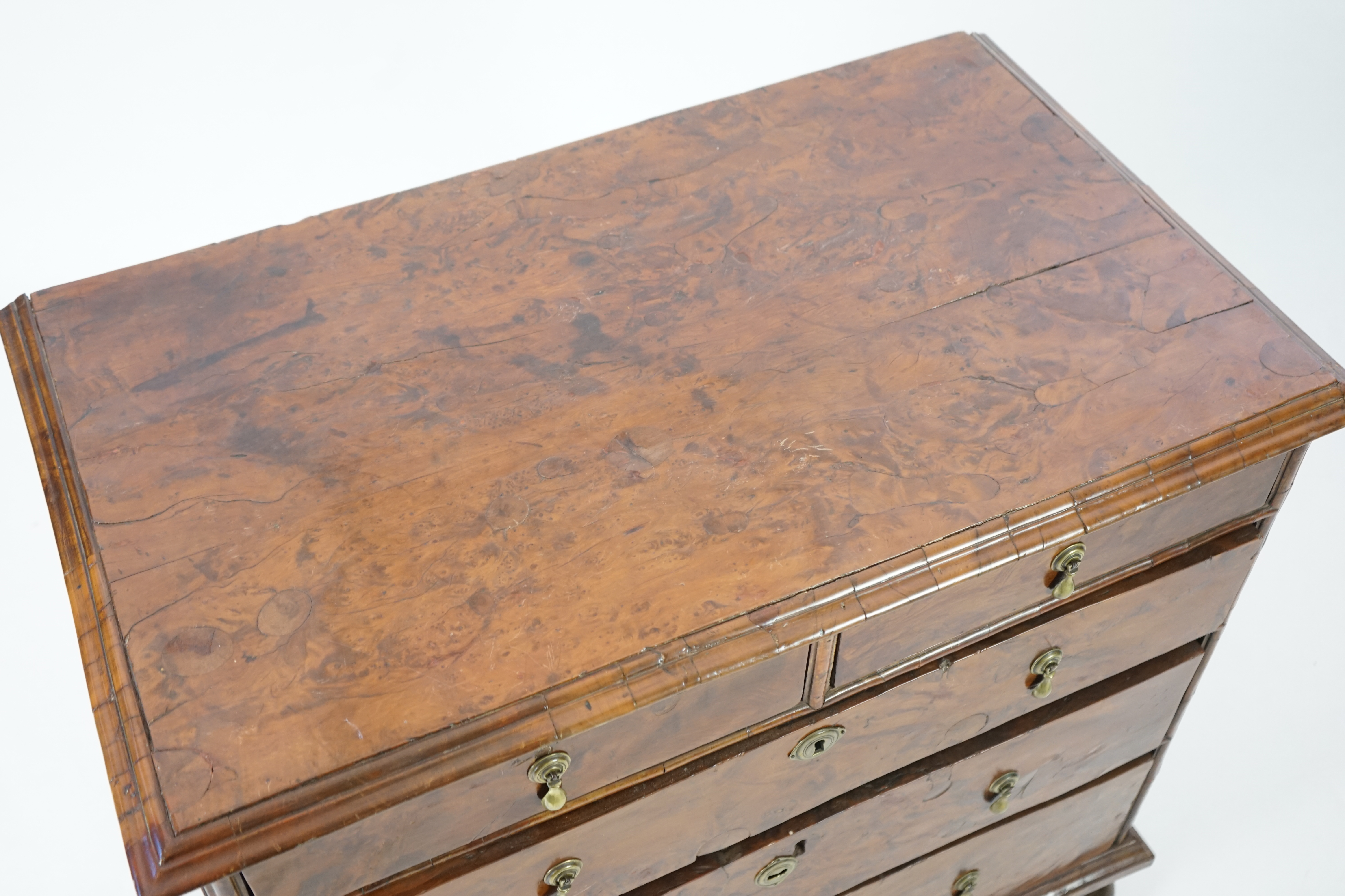 An early 18th century and later yew wood veneered oak chest